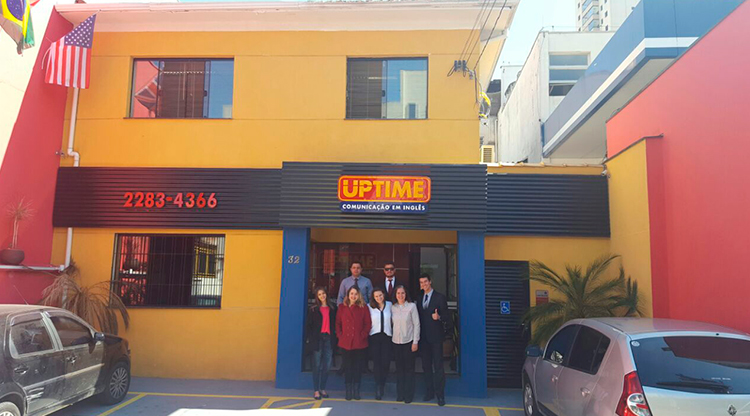 Diretores do negócio na fachada da unidade